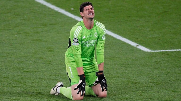 Real Madrid's goalkeeper Thibaut Courtois celebrates at the end of...