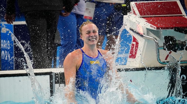 Sarah Sjoestroem, of Sweden, celebrates after winning the women's 100-meter...