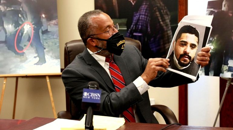 Attorney Frederick Brewington shows a photograph of his client, Christopher...