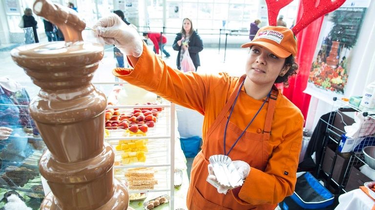 Anna Sporri, of Valley Stream, serves chocolate during the Chocolate...