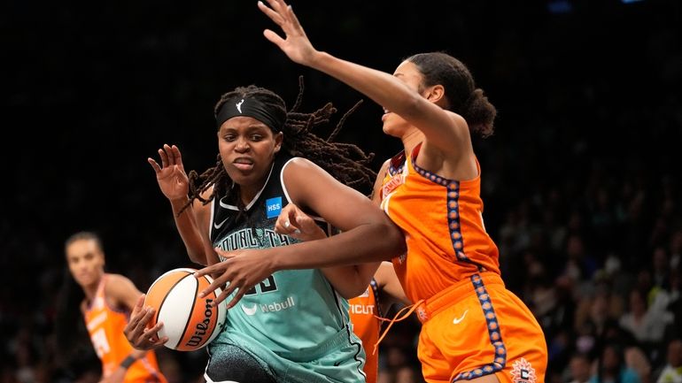 Connecticut Sun forward Olivia Nelson-Ododa, right, guards New York Liberty...