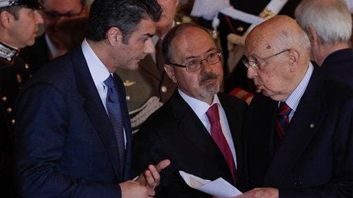 Unidentified aides give Italian President Giorgio Napolitano the news about...