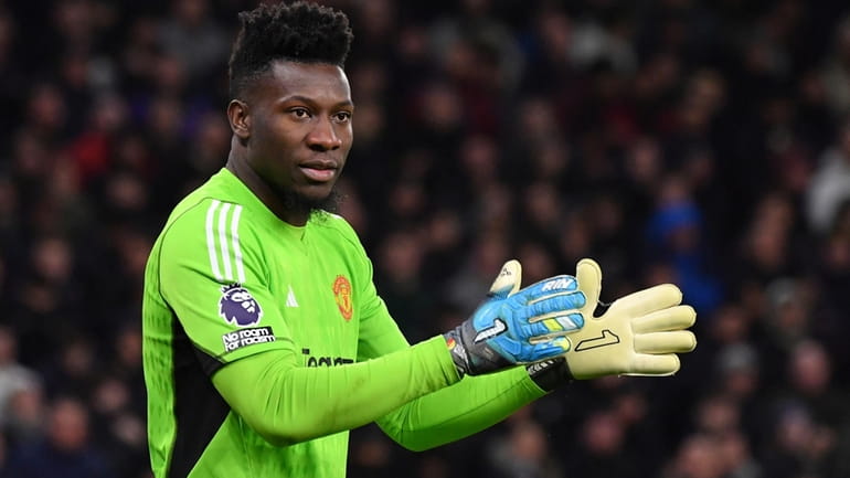 Manchester United's goalkeeper Andre Onana applauds during the English Premier...
