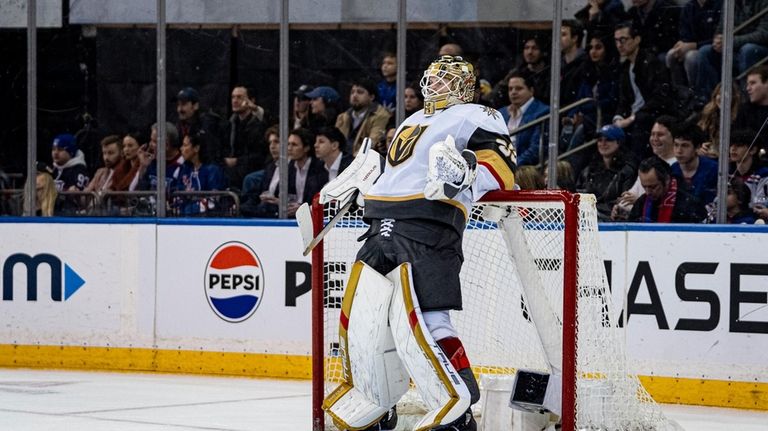 Vegas Golden Knights goaltender Adin Hill rests against the goal...