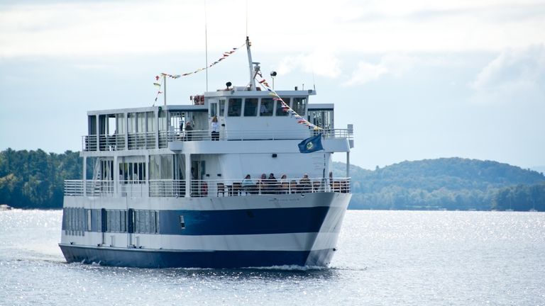 Sightseers line the prow of the passenger ship Spirit of...