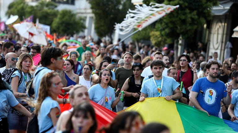 Revellers take part in EuroPride, a pan-European international LGBTI event...