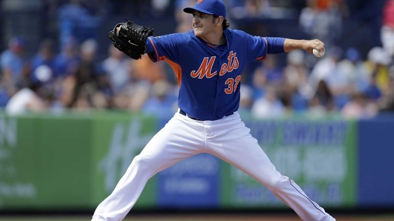 Mets starting pitcher John Lannan throws during the first inning...