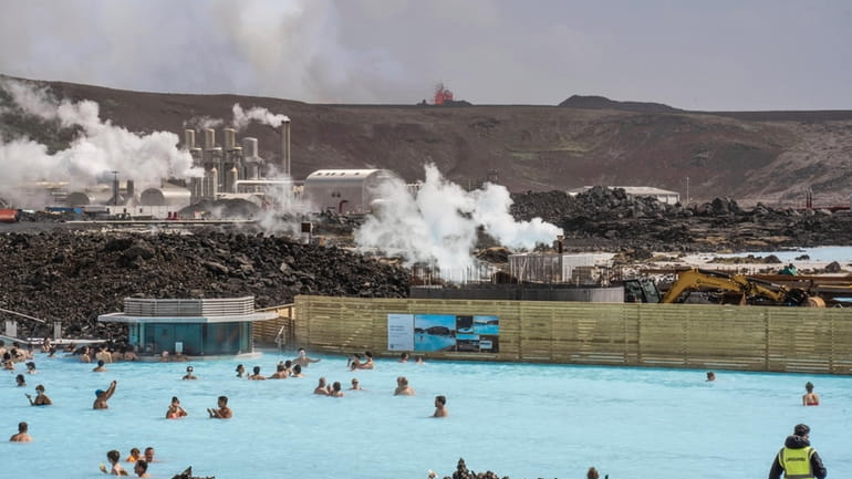 The Blue Lagoon with people bathing in it as the...
