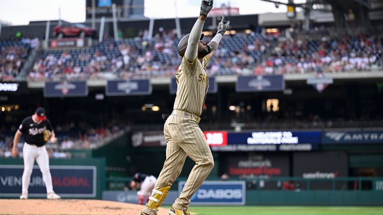 San Diego Padres' Jurickson Profar, right, runs past Washington Nationals...