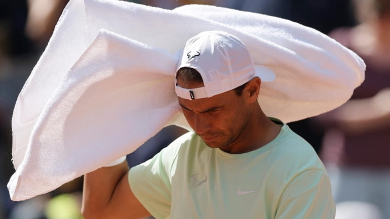 Spain's Rafael Nadal uses his towel as he trains at...