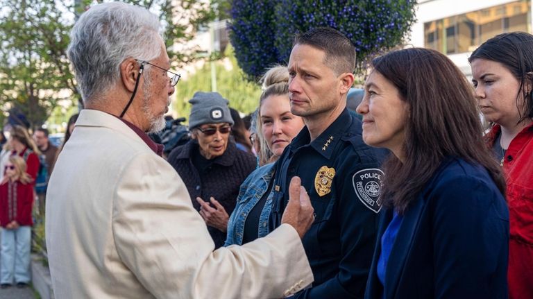 Rev. Samuel Unutoa speaks with Mayor Suzanne LaFrance and Police...