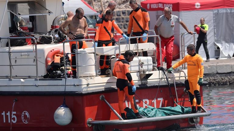 Italian firefighter divers bring ashore in a plastic bag the...