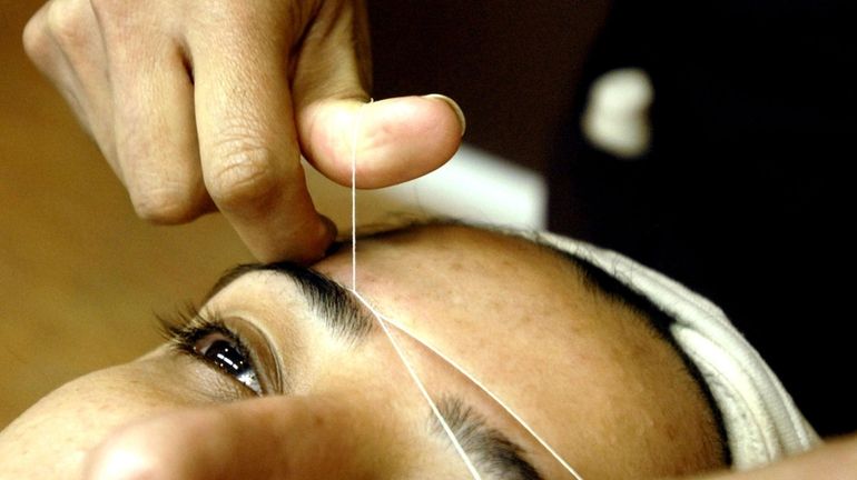 Chetna Parikh threads a client's eyebrows on March 31, 2010.