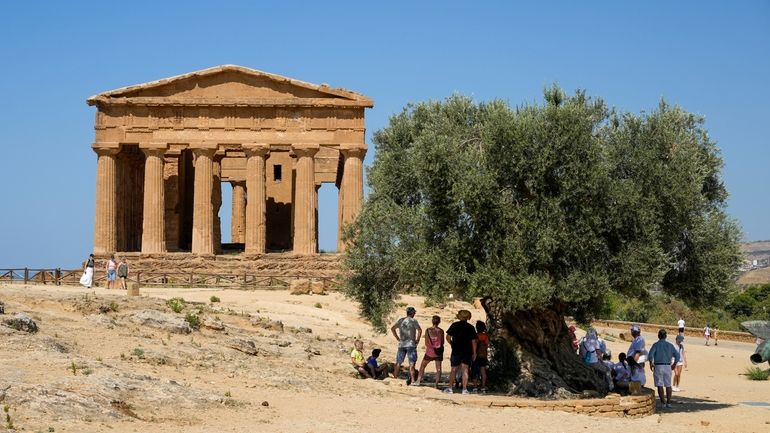 Visitors admire the ancient Greek Concordia temple, known as the...