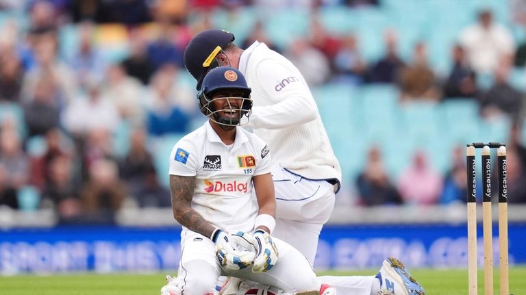 Sri Lanka's Pathum Nissanka reacts after diving to make up...