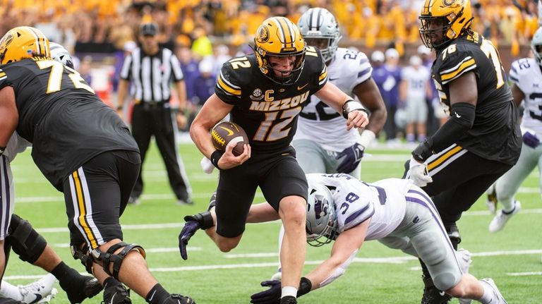 Missouri quarterback Brady Cook scores a touchdown during the second...