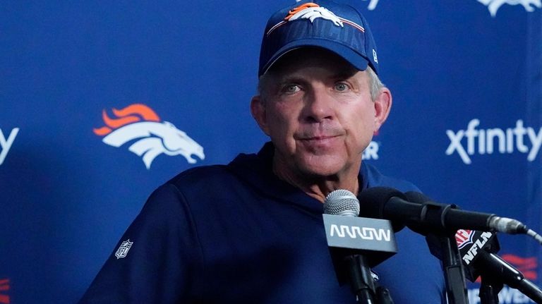 Denver Broncos head coach Sean Payton listens to a question...