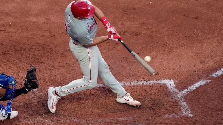 Philadelphia Phillies' J.T. Realmuto hits a three-run home run during...