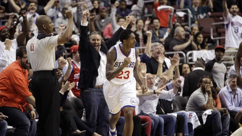 Philadelphia 76ers' Lou Williams (23) reacts with fans after making...