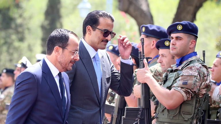 Cyprus' President Nikos Christodoulides, left, and Qatar's Emir Sheikh Tamim...