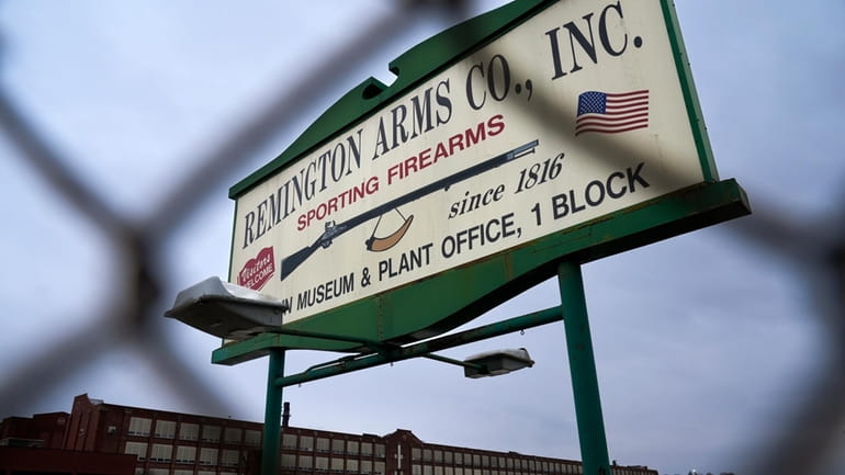 A sign for Remington Arms Co. is displayed in front...