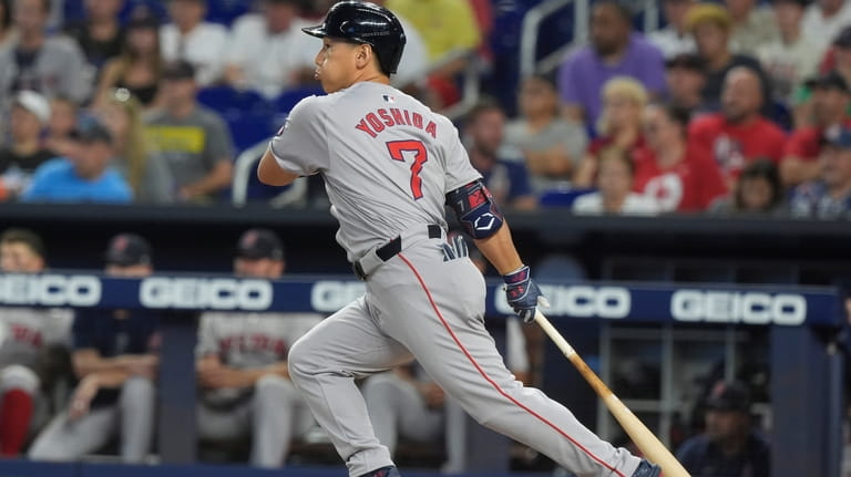 Boston Red Sox's Masataka Yoshida (7) hits a single during...