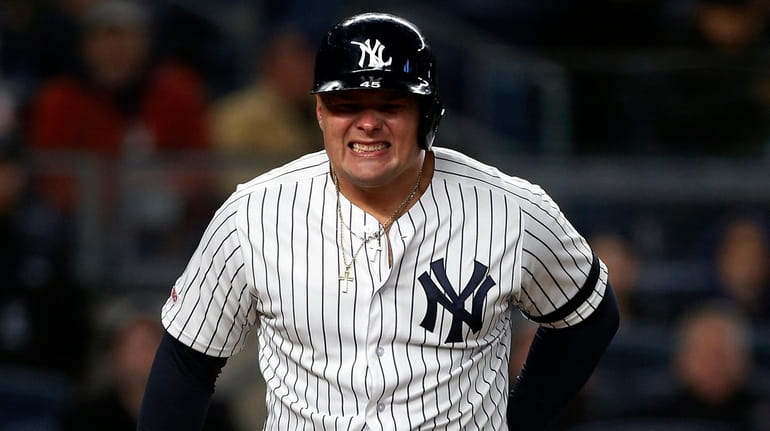 Luke Voit of the Yankees reacts after he was hit by a...
