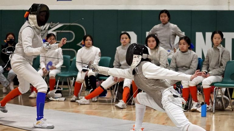 Ward Melville's Kiki Liu, right, goes up against Great Neck South's...