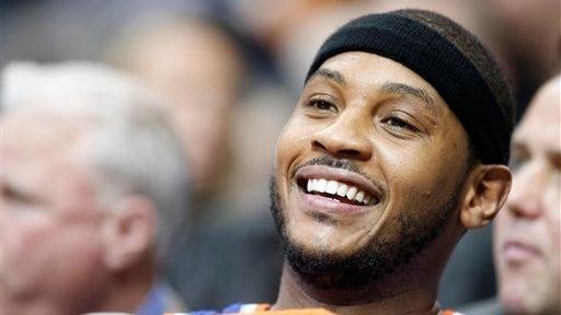 Carmelo Anthony looks on during the second half of a...