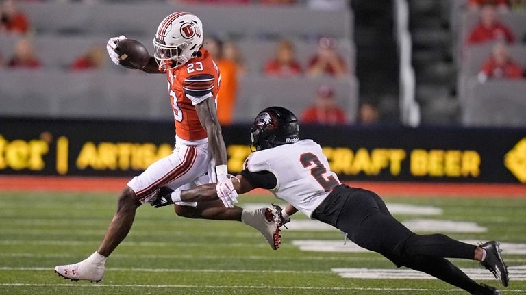 Southern Utah cornerback Devyn Perkins (2) reaches for Utah running...