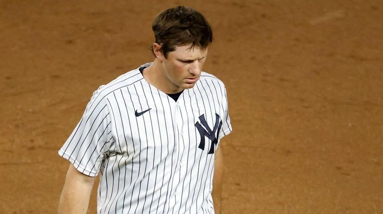 Yankees second baseman DJ LeMahieu grimaces as he walks off...