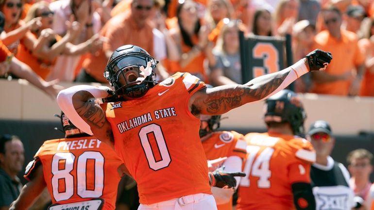 Oklahoma State running back Ollie Gordon II (0) celebrates in...