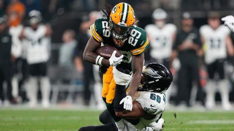 Green Bay Packers safety Xavier McKinney (29) is tackled by...