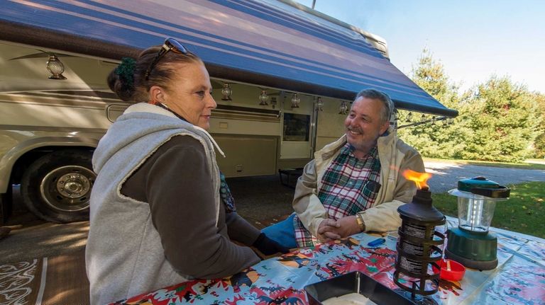 Karen and Gary Higgins of Greenlawn settle in with their...