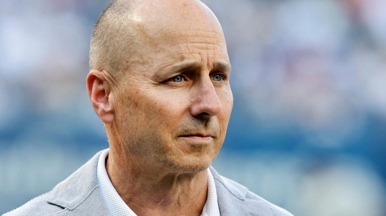 Yankees general manager Brian Cashman looks on before a game...