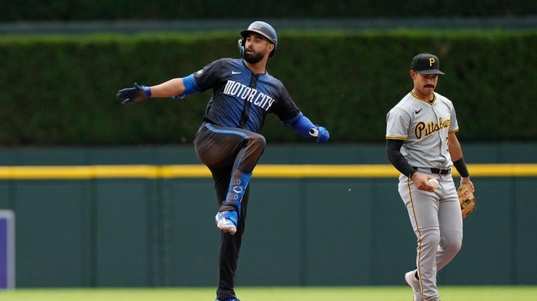 Detroit Tigers' Riley Greene signals towards the dugout after his...