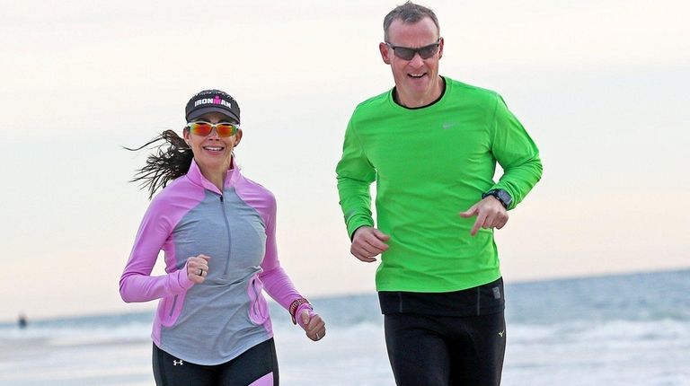 Massachusetts native Matt Conroy runs with his fiancee, Eliana Themistocleous,...