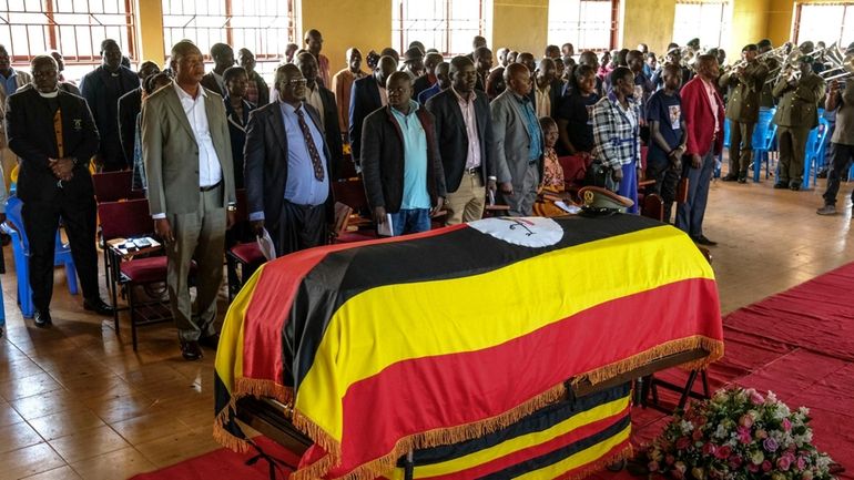 Members of the public gather for a funeral service of...