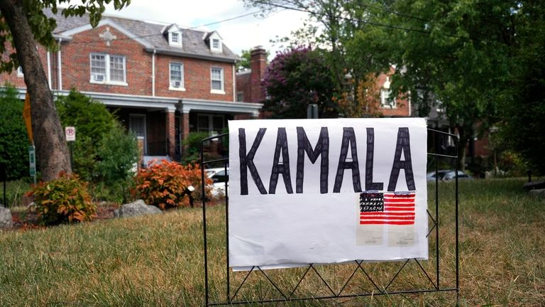 A handmade sign for Vice President Kamala Harris appears on...