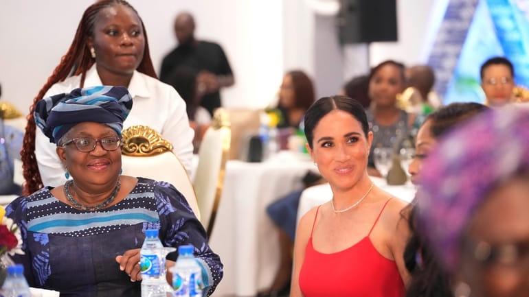 Meghan, the Duchess of Sussex, right, sits by Ngozi Okonjo-Iweala,...
