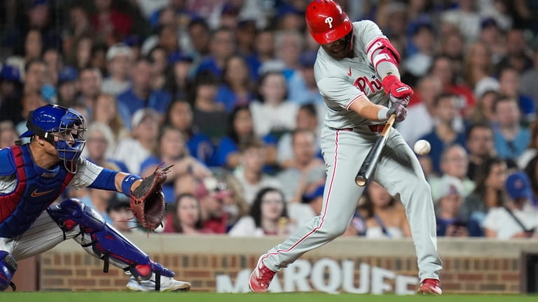 Philadelphia Phillies' Whit Merrifield hits a single during the eighth...