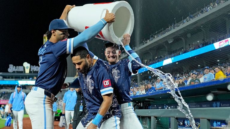 Kansas City Royals' Tommy Pham, center, is doused by MJ...