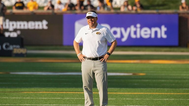 Missouri head coach Eliah Drinkwitz watches his team warm up...