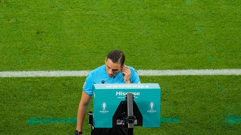 The referee checks the VAR for possible penalty for Georgia...