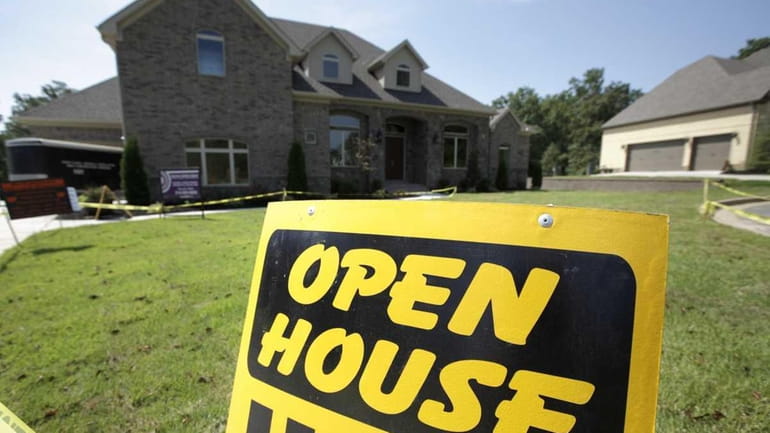 An "Open House" sign is seen in front of a...