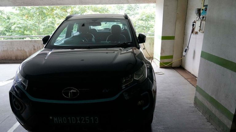 A car gets charged at an Electric Vehicle charging station...