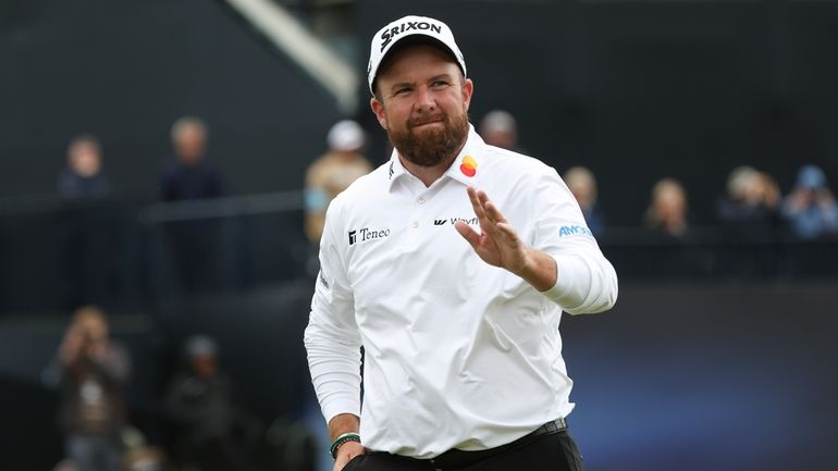 Shane Lowry of Ireland waves as he walks from the...