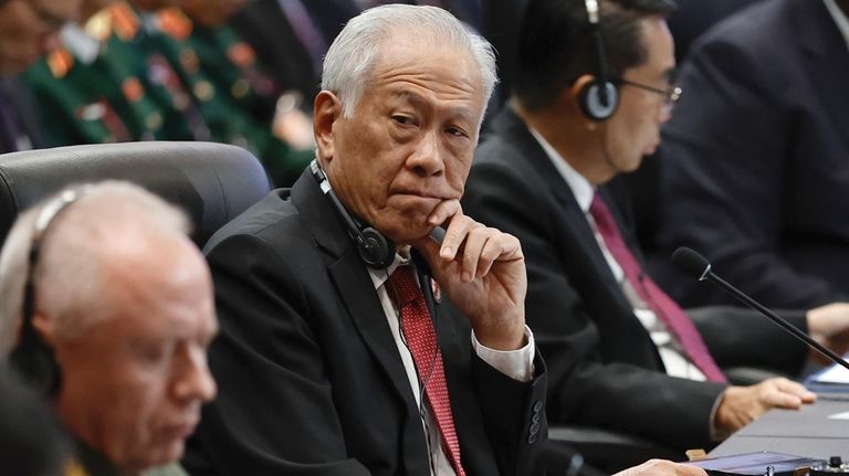 Singapore's Defense Minister Ng Eng Hen, center, attends the Association...