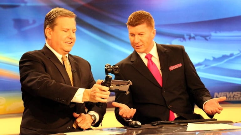 News 12 Long Island's Andrew Ehinger shows Stone Grissom how...