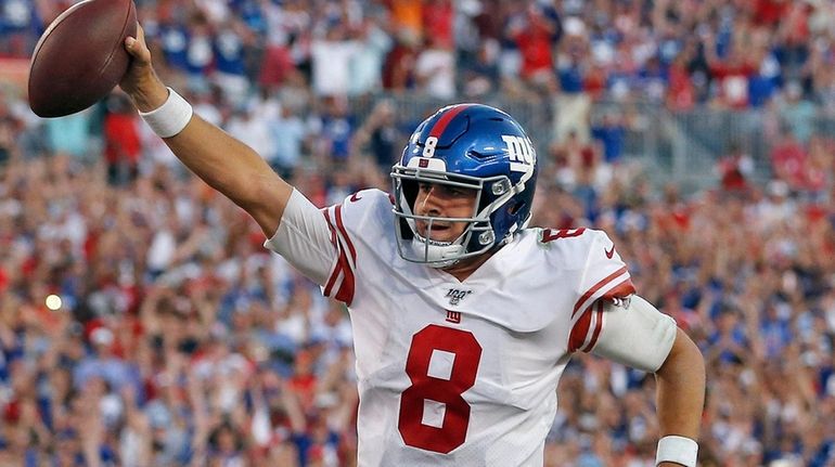 Giants quarterback Daniel Jones runs seven yards for a touchdown...